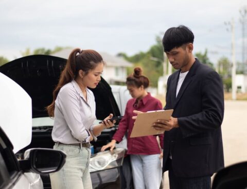 Person reviewing no-fault insurance in New York policy documents after a car accident