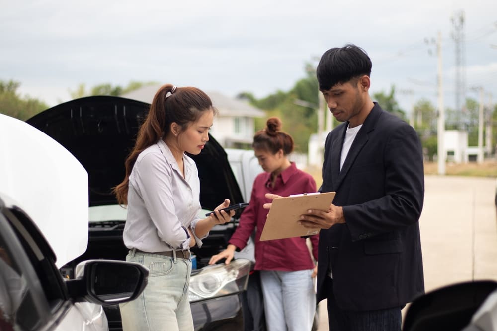 Person reviewing no-fault insurance in New York policy documents after a car accident