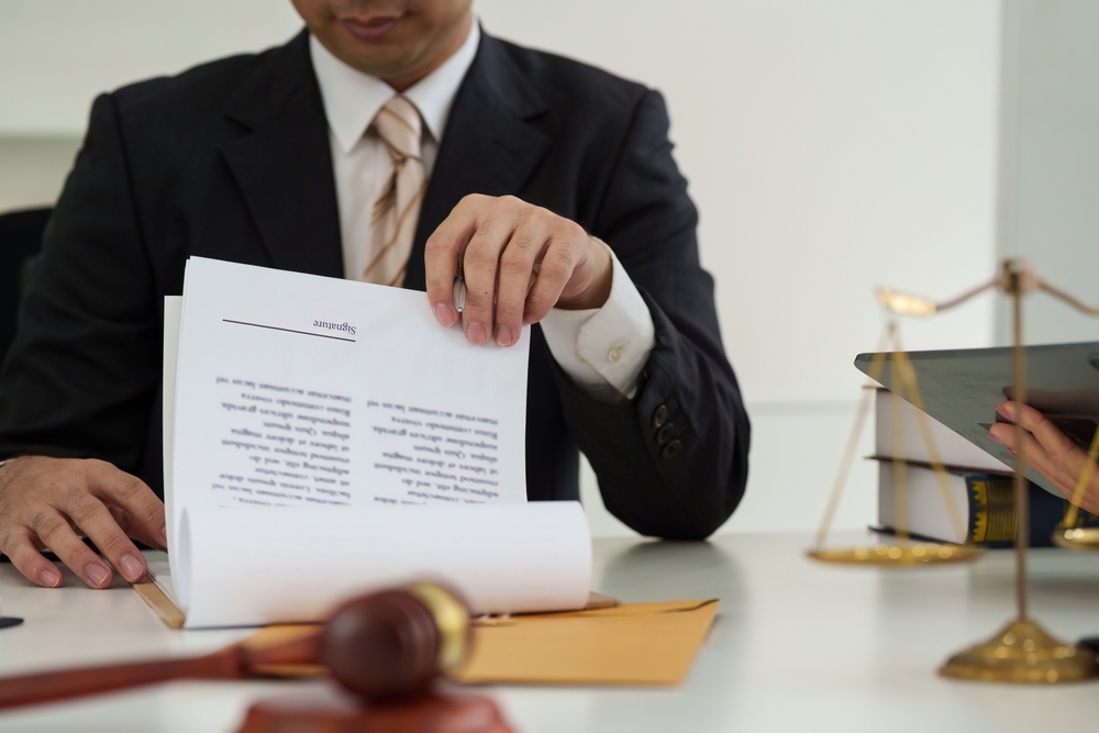 Attorney reviewing documents with client to prevent personal injury claim mistakes