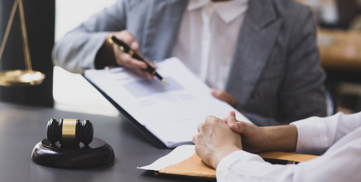 Attorney reviewing documents with a client during a personal injury deposition proceeding in a legal office