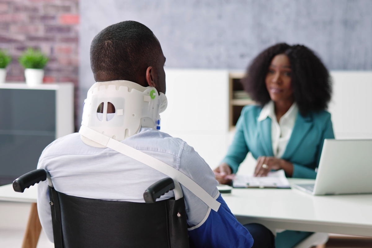 Bicycle accident lawyer in Bayonne NJ consulting with a seriously injured client in a wheelchair during a free legal consultation