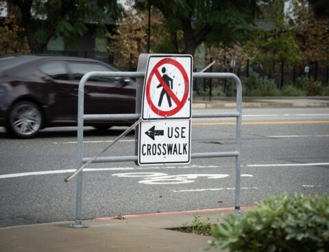 "No Pedestrian Crossing, Use Crosswalk" sign at a city street, illustrating a jaywalking accident claim in NY