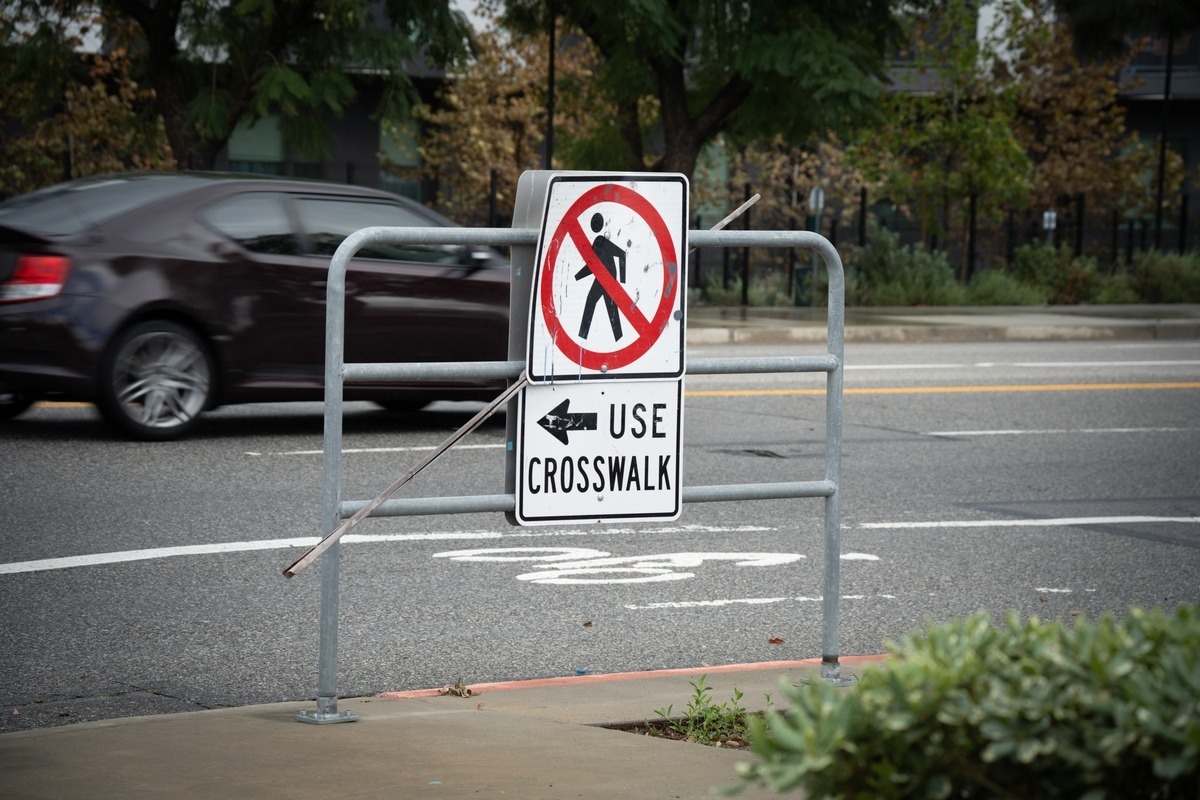"No Pedestrian Crossing, Use Crosswalk" sign at a city street, illustrating a jaywalking accident claim in NY