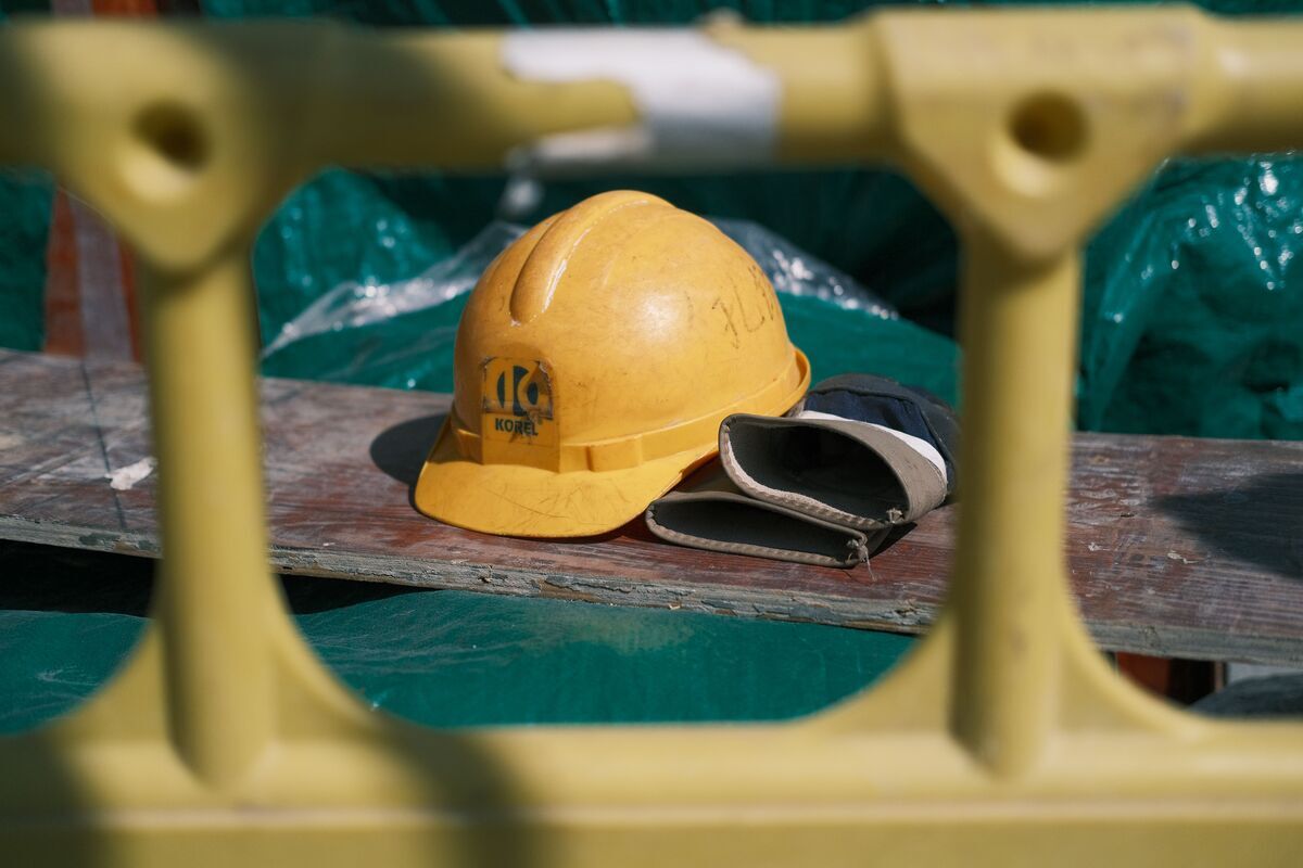 Hard hat and work gloves set aside at a job site, representing a work injury claim in NY