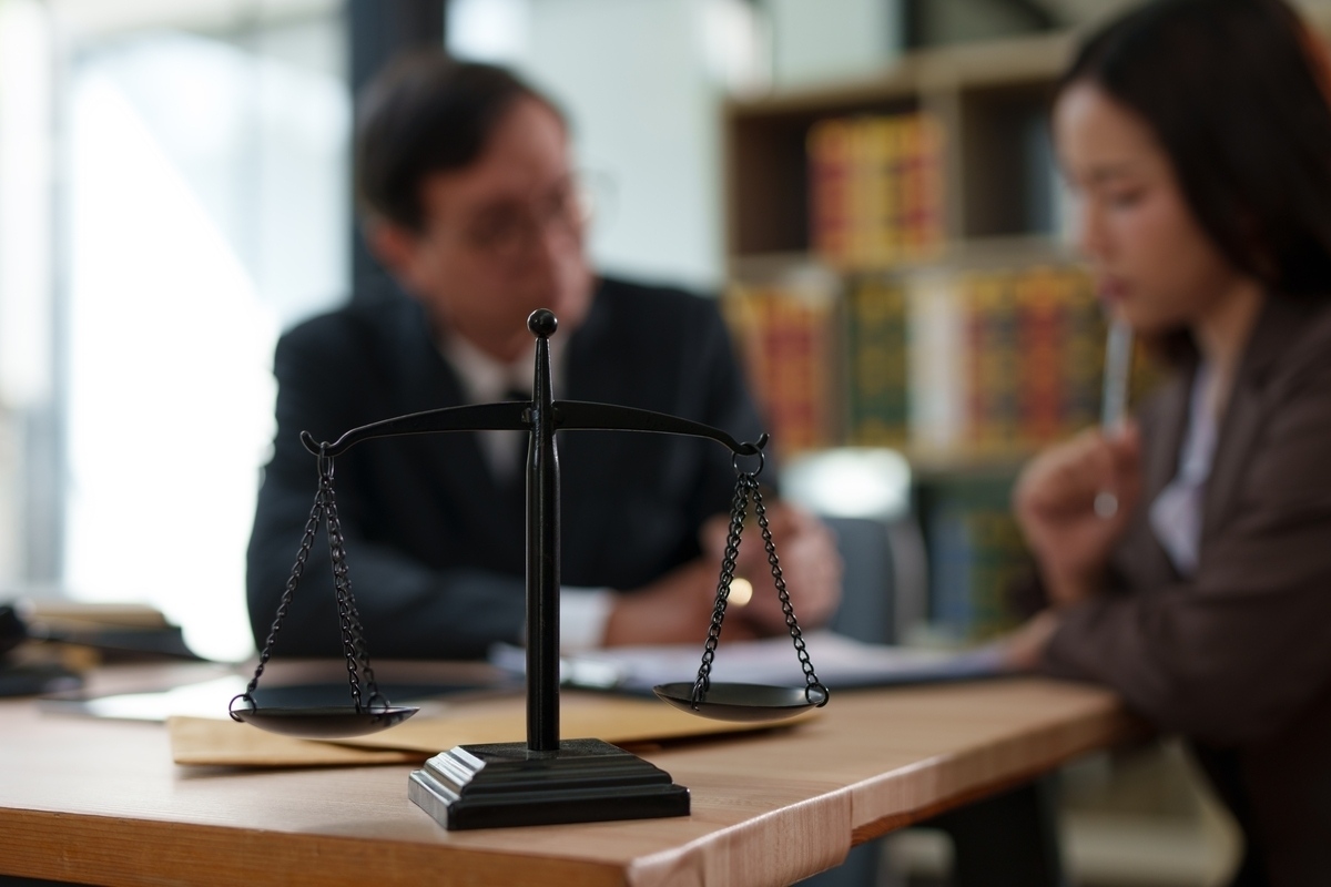 Scales of justice on a desk, symbolizing a wrongful death vs survival action claim in New York